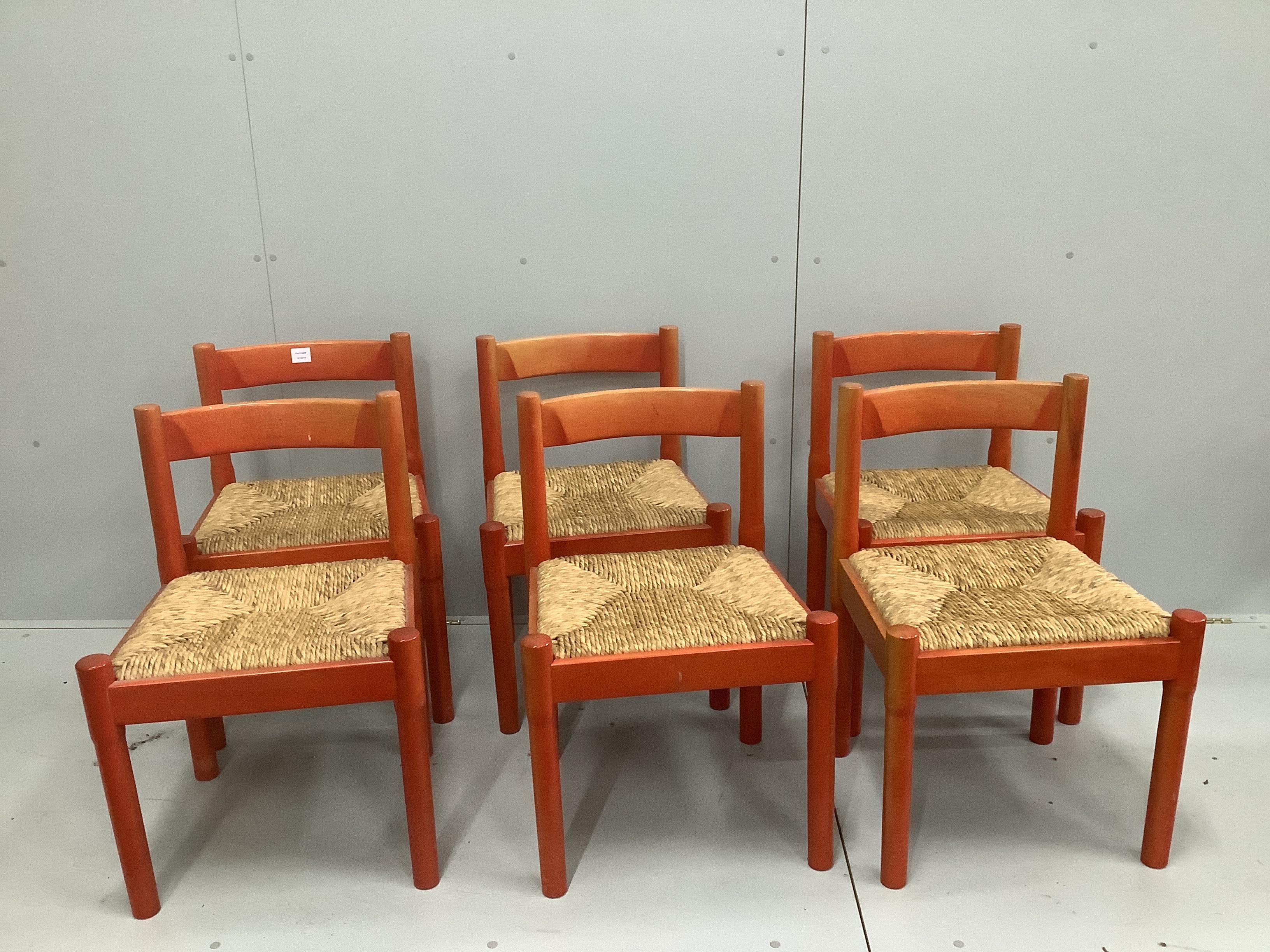 A set of six Conran Magistretti red stained beech dining chairs with rush work seats